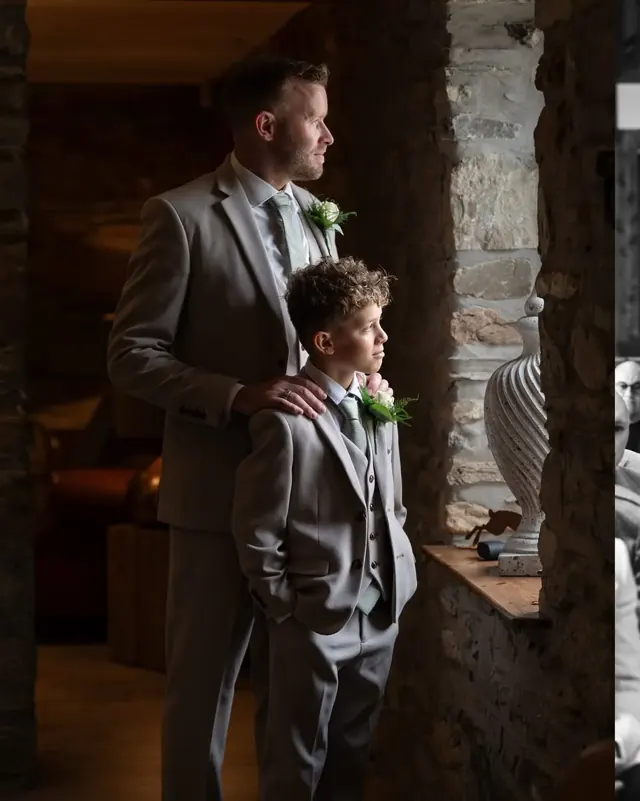 Groom and his son looking out of a window