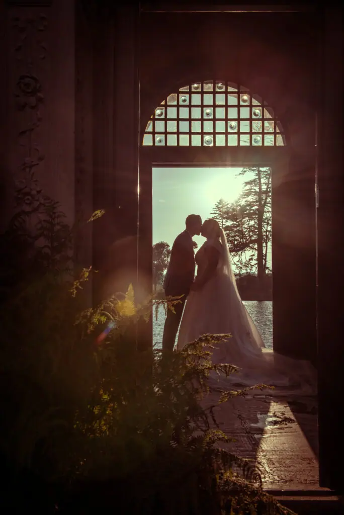 Couple kissing in a glowing arched doorway
